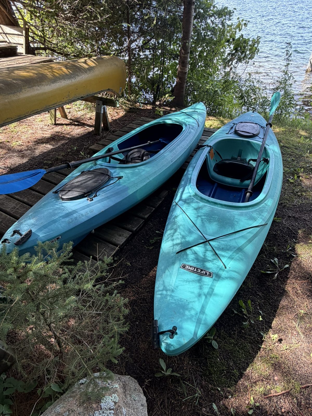 Kayaks and a canoe at the cabin